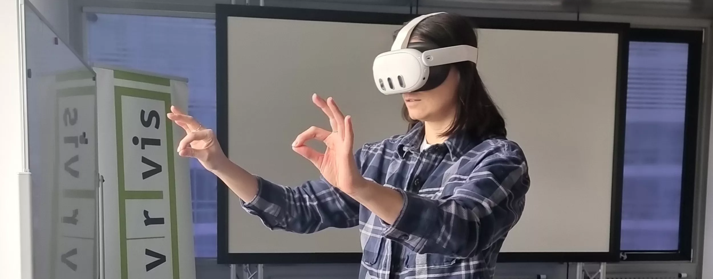 Woman wearing Meta Quest 3 virtual reality headset making pinching gestures in an office environment. 