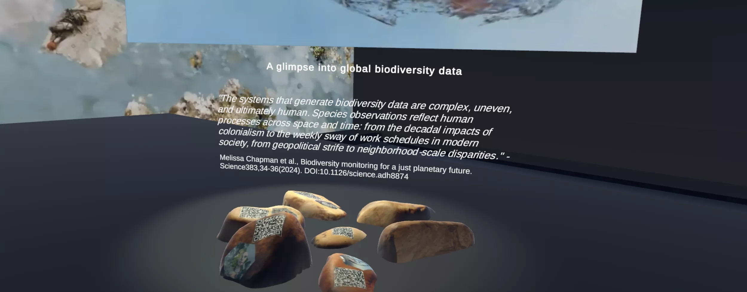 A digital exhibition display showcasing a theme on global biodiversity data. In the center, there is a floating image of a globe with a hazy, semi-transparent texture, appearing to represent biodiversity. Below the globe, a quote discusses the complexity and human influence on biodiversity data. The exhibition is set in a dark, immersive virtual space.