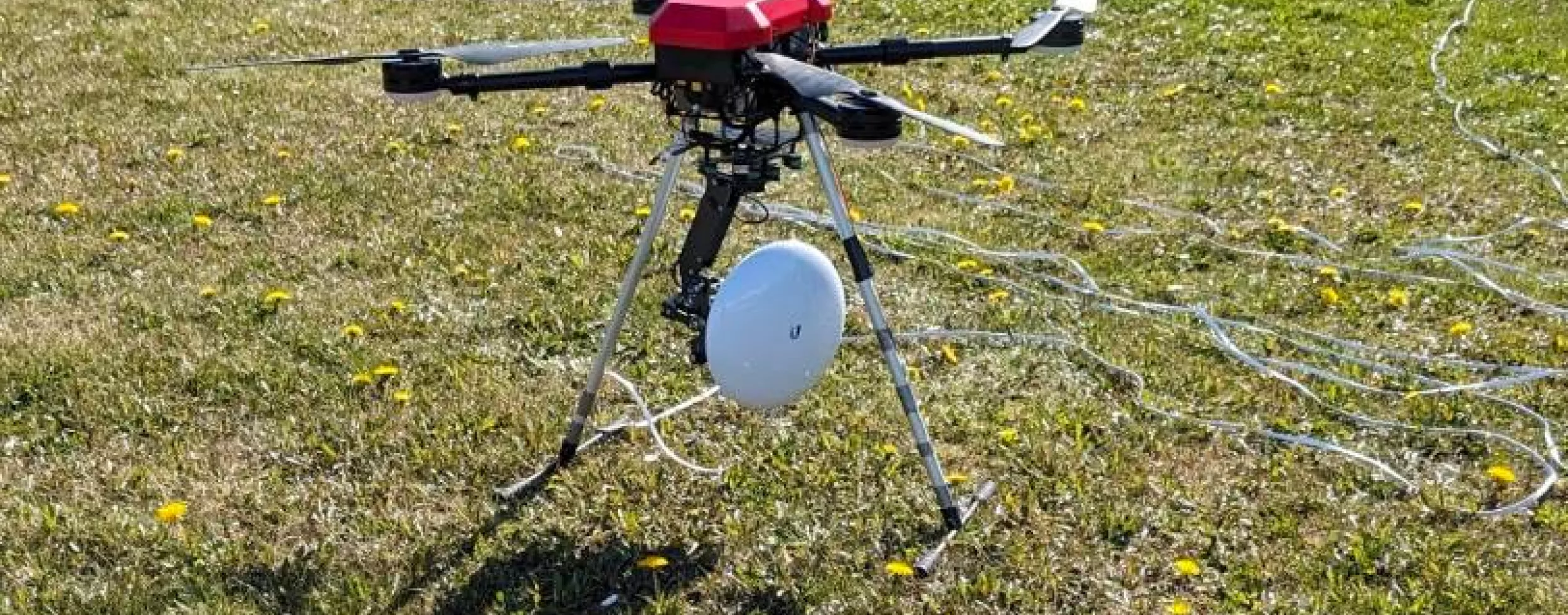 A drone with a directional antenna mounted between the legs